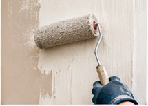 Painter applying a smooth coat of paint